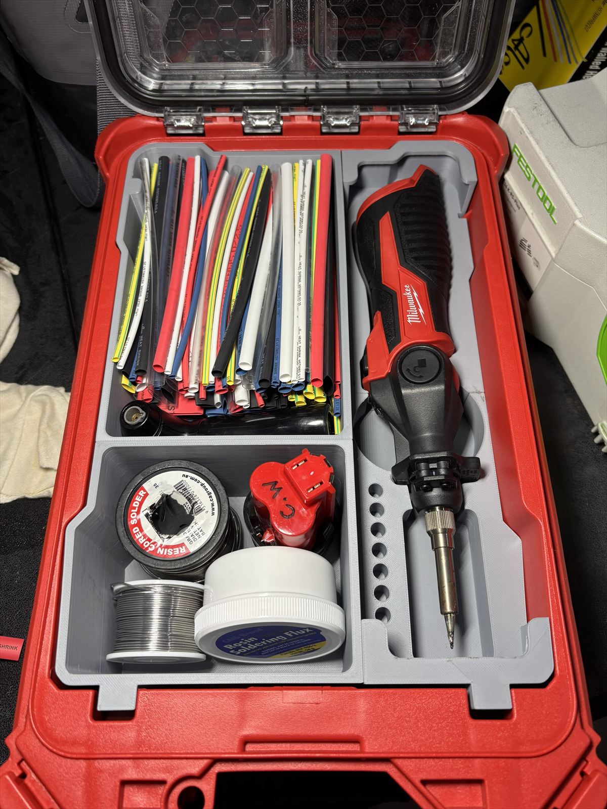 Custom foam-style insert holding a soldering kit in a tool case